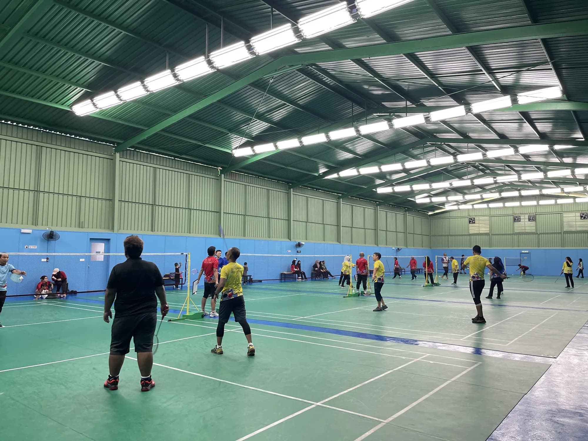 The badminton hall at Sports Center, looking down the full span of the courts